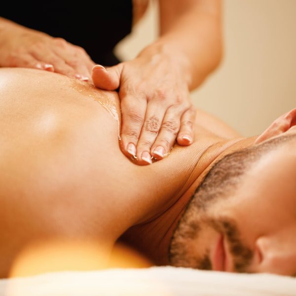 closeup-man-enjoying-relaxing-back-massage-with-honey-spa (1)